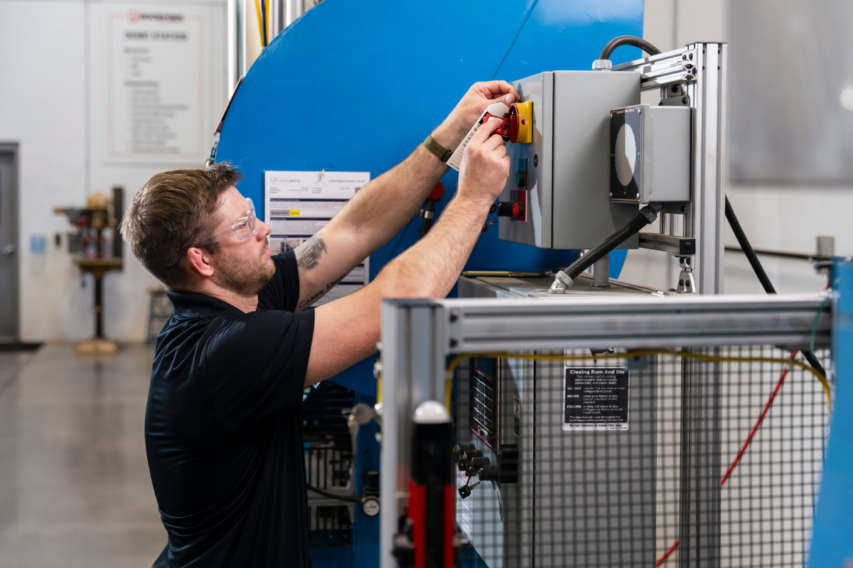 Man Performing Lockout Tagout Procedures On a Machine